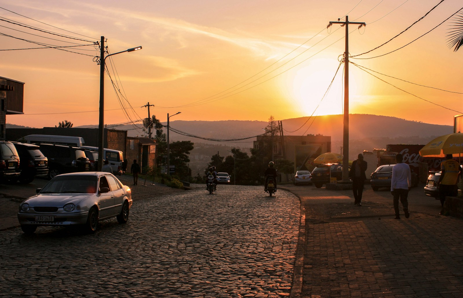 people walking on sidewalk during sunset